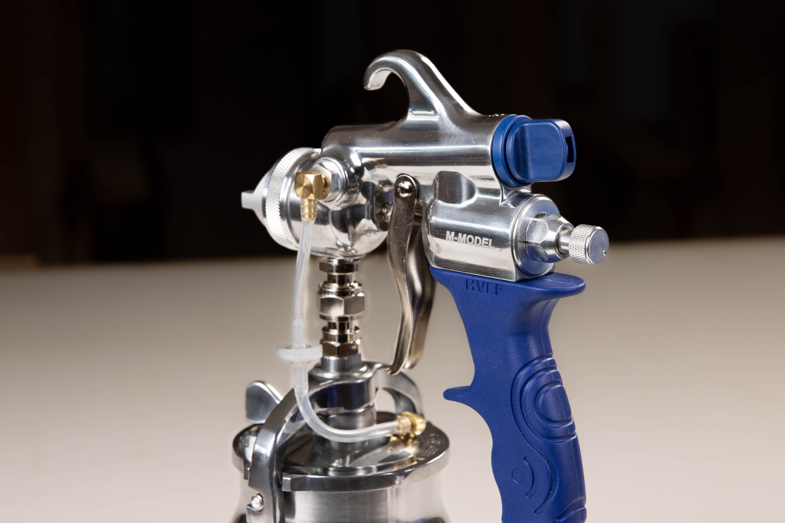 Close up of handle of the M-Model bottom feed spray gun.