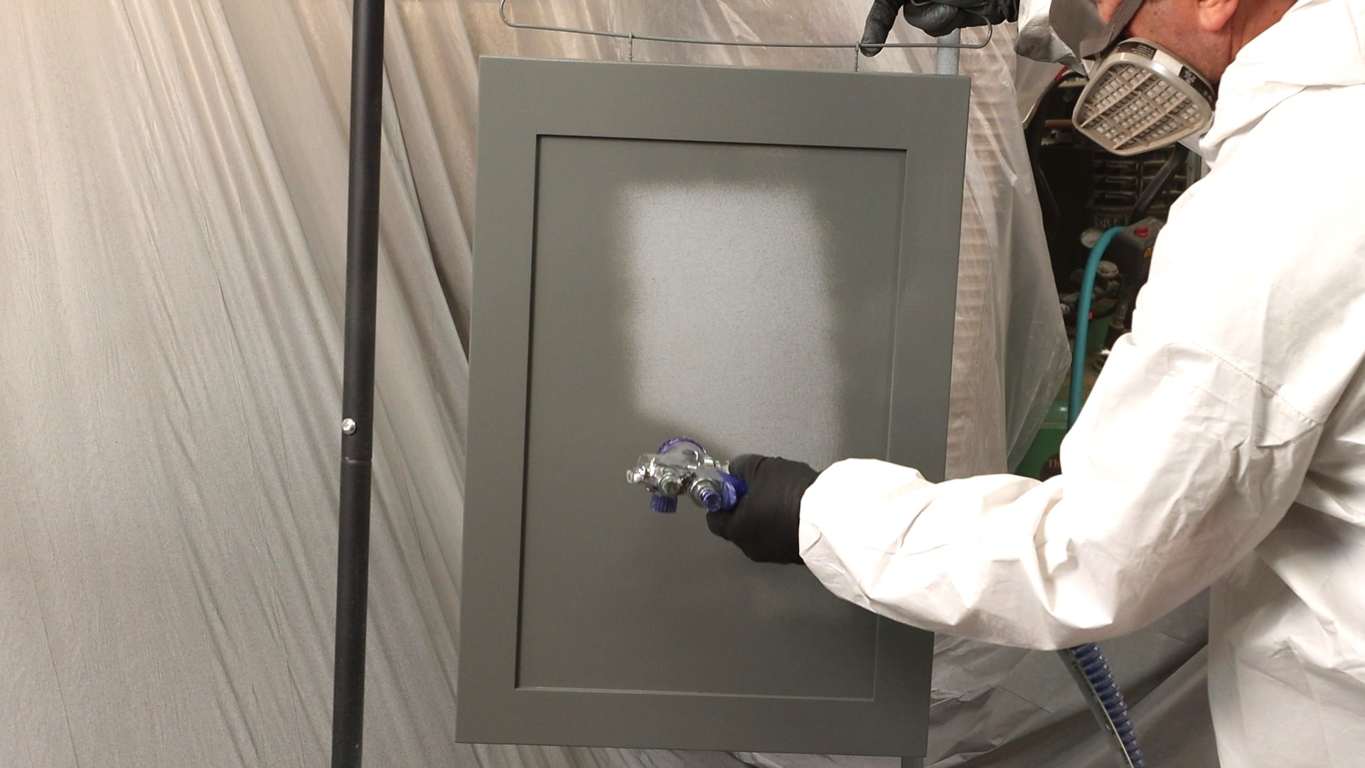 Spraying a cabinet panel