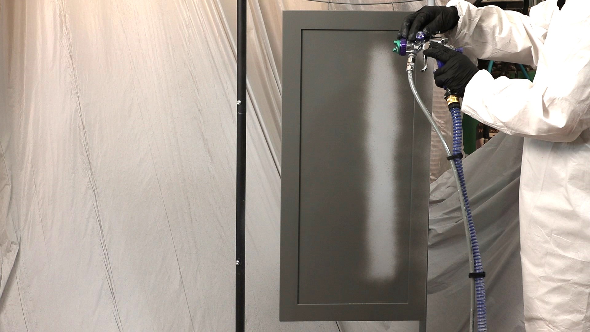 Spraying the cabinet panel.