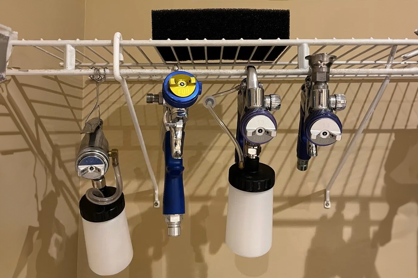 Different HVLP spray guns and turbine filter hanging to dry